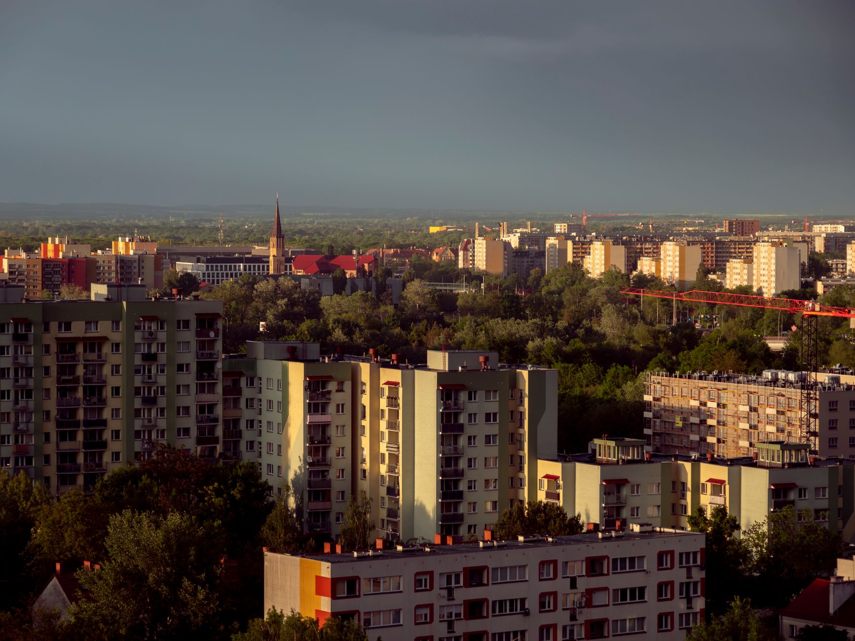 Aerial view of Wrocław showcasing urban architecture and a serene sunset backdrop.