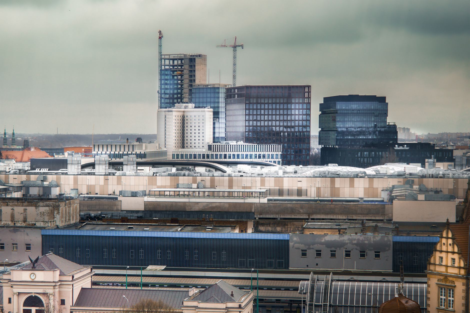 Modern architectural skyline view of Poznań with overcast skies, highlighting urban development.