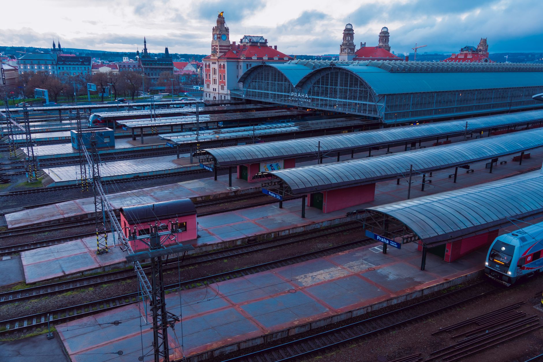 Aerial view of the iconic Prague main railway station, showcasing modern architecture and urban transportation.