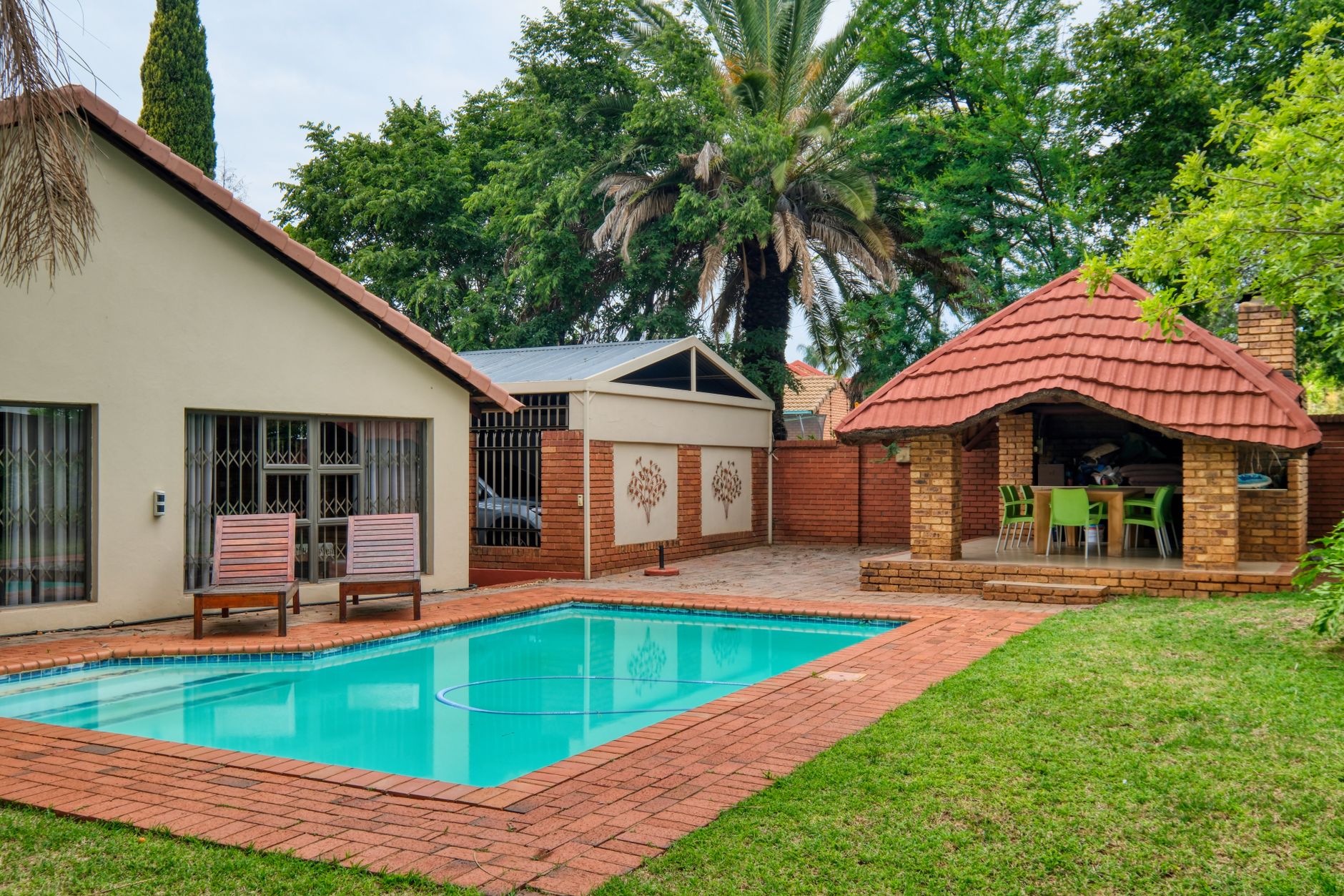 Charming suburban home in Pretoria with a pool and lush greenery.